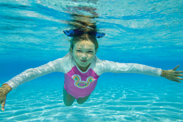 Child swimming in promotion of Disney waterpark seasonal pass