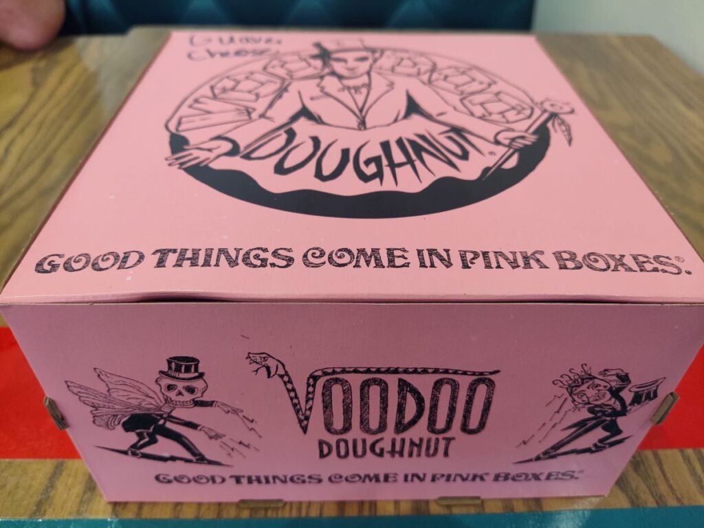 Signature pink box with Voodoo Doughnut desgin on top
