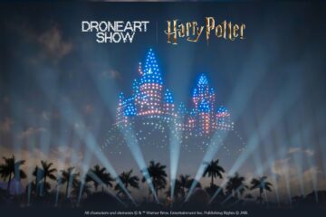 Nighttime light show: a castle built from blue and white LEDs with 'DRONEART SHOW' and 'Harry Potter' text above.