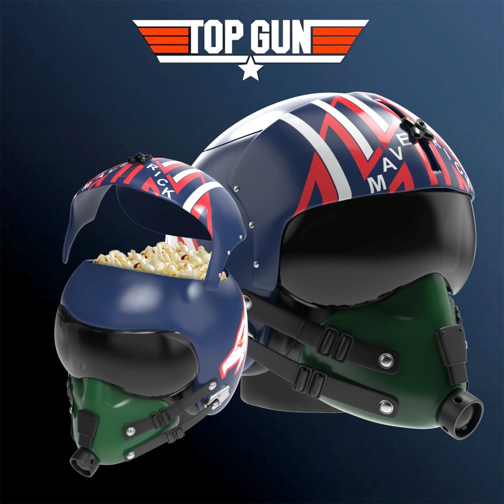 Two Top Gun popcorn buckets themed flight helmets with red, white, and blue graphics; popcorn spills from the left helmet, logo above on a dark background.