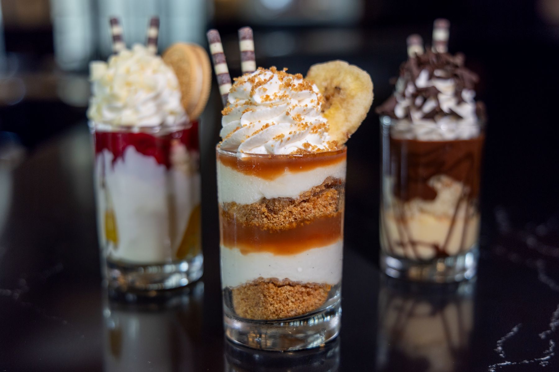 Layered caramel and vanilla parfait topped with whipped cream, crushed biscuits, and a heart-shaped cookie for The Tasting Tour at the Hard Rock Hotel