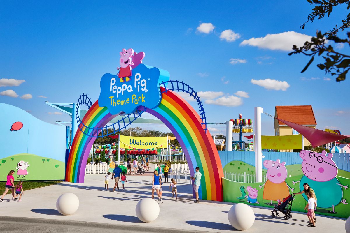 Entrance to Peppa Pig Theme Park with a large rainbow arch and cartoon characters at the gate