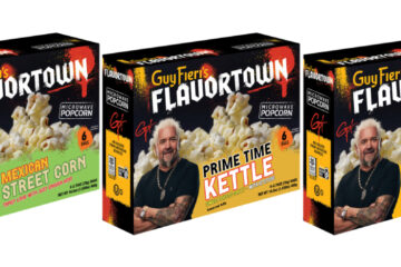 Five boxes of Guy Fieri's Flavortown microwave popcorn in a row, each with a different flavor: Straight Up Popcorn, Mexican Street Corn, Prime Time Kettle, Big Bite Butter, Cinnamon Butter Bomb.