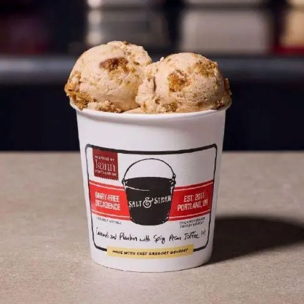 Cup of two scoops of the Salt & Straw June 2026 ice cream atop a branded cup with a red and white label.