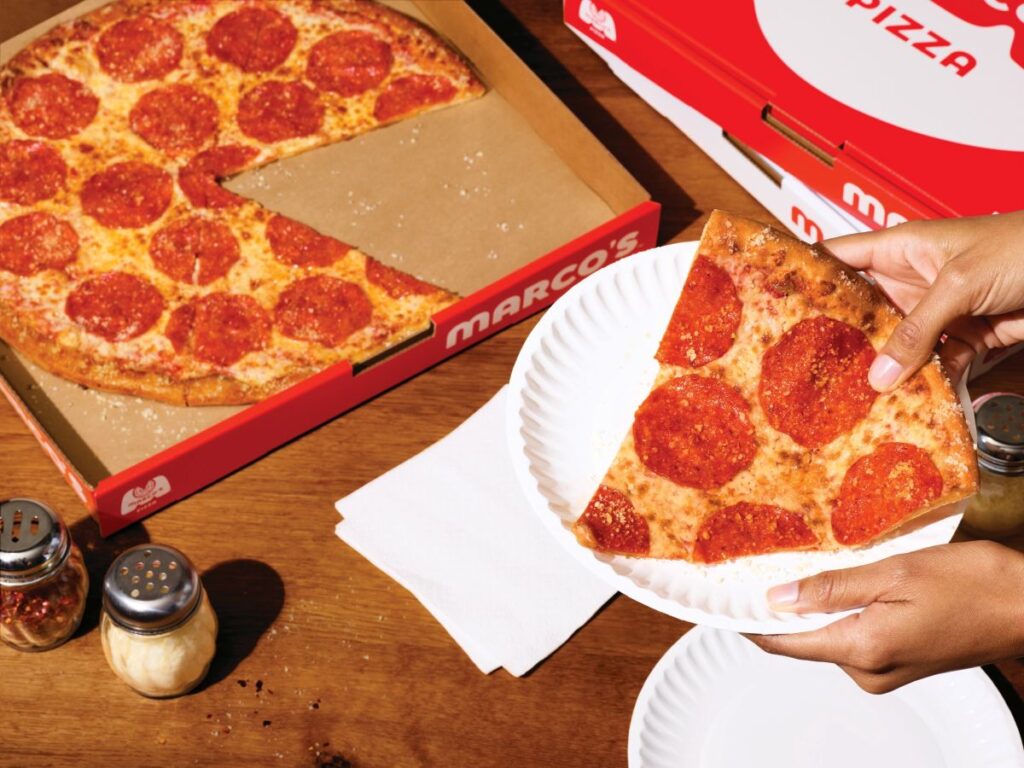 Marco's NY Style Pizza shown With Big Slice On Plate Next To Box