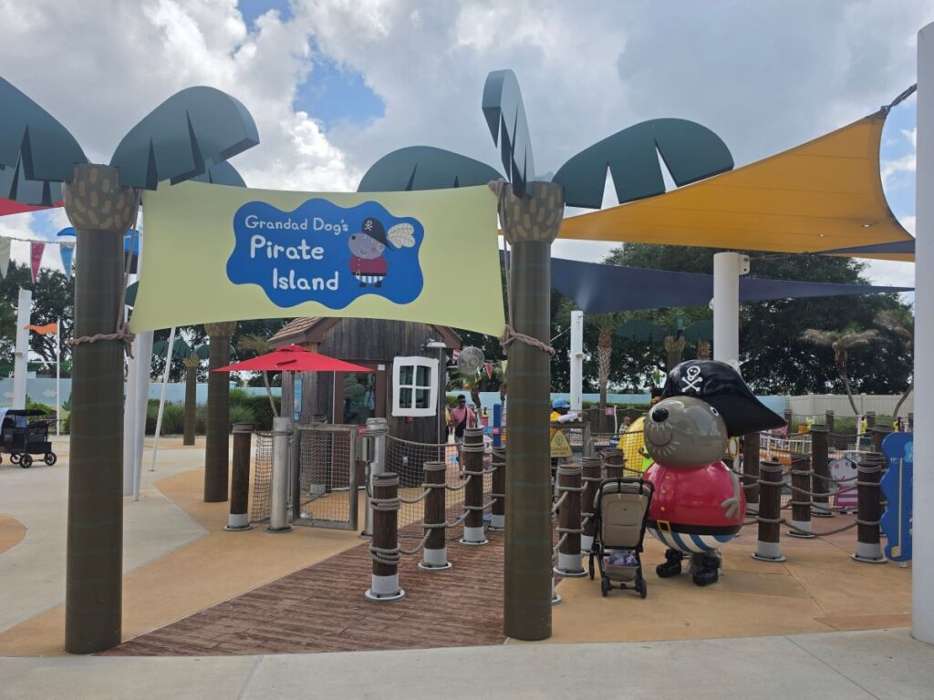 Entrance to a pirate-themed play area with a sign that reads 'Grandad Dog's Pirate Island' and rope barriers.