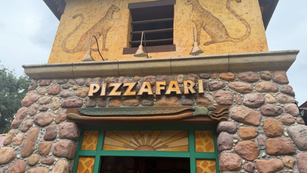 Stone facade of a restaurant with a bold 'PIZZAFARI' sign above the doorway.