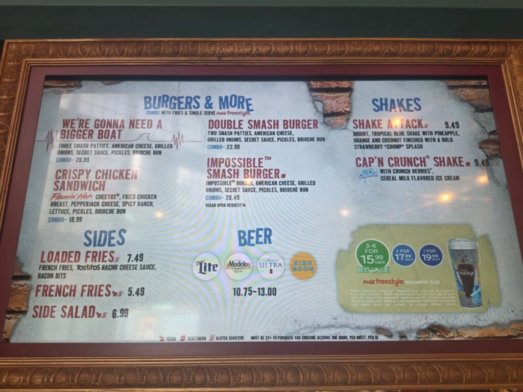 Framed restaurant menu board showing burgers, shakes, sides, and beer offerings like Loaded Fries and Cap'n Crunch Shake for Richter's Burger Co Review