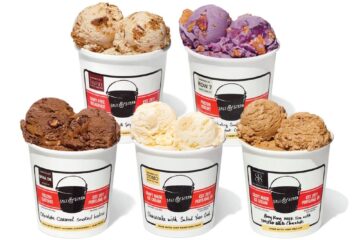 Five cups of assorted Salt & Straw June 2026 ice cream flavors in white takeaway containers with red-and-black labels, arranged in two rows on a white background.