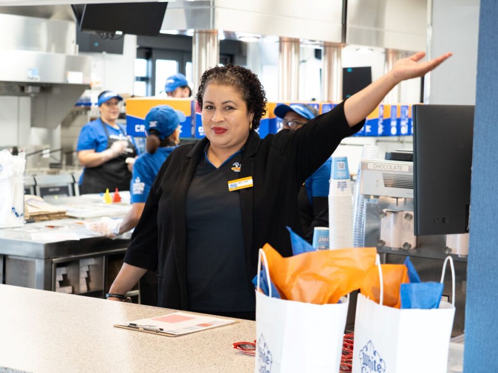 Employee greeting fans when White Castle Kissimmee opened