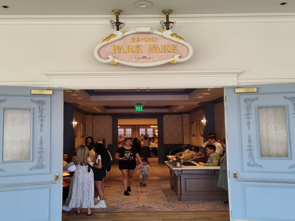 Open entry to 1900 Park Fare breakfast; blue double doors frame a busy dining lobby with guests inside.