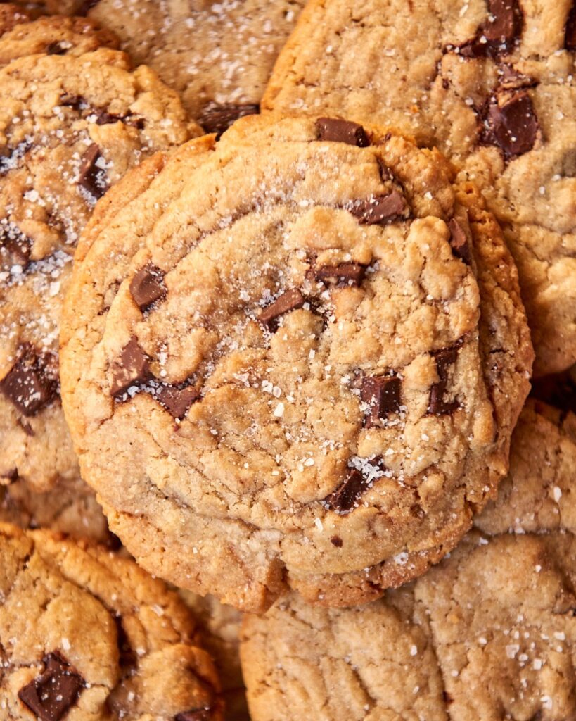 Close-up of sugar-dusted chocolate chip cookies with visible chunks of chocolate.