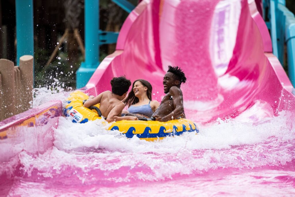 Three people riding Solar Vortex at AquaGlow Adventure Island Tampa