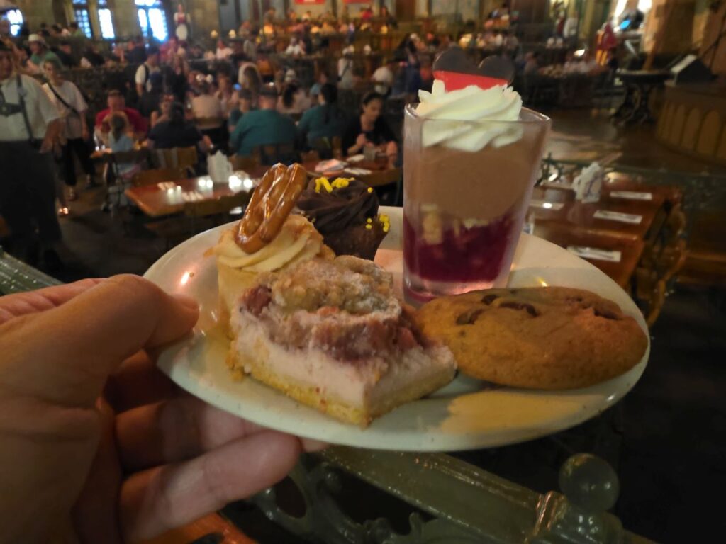 Biergarten Epcot review- plate shown with a small chocolate dessert and a piece of apple streudel