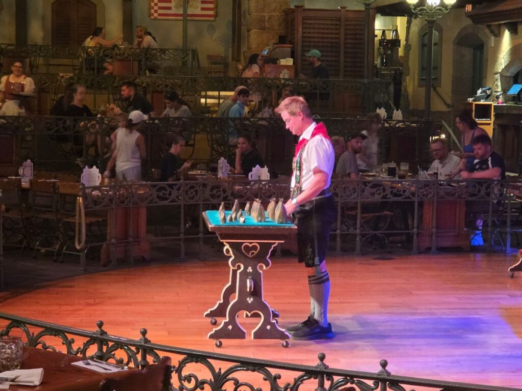 German performer playing the bells at Biergarten