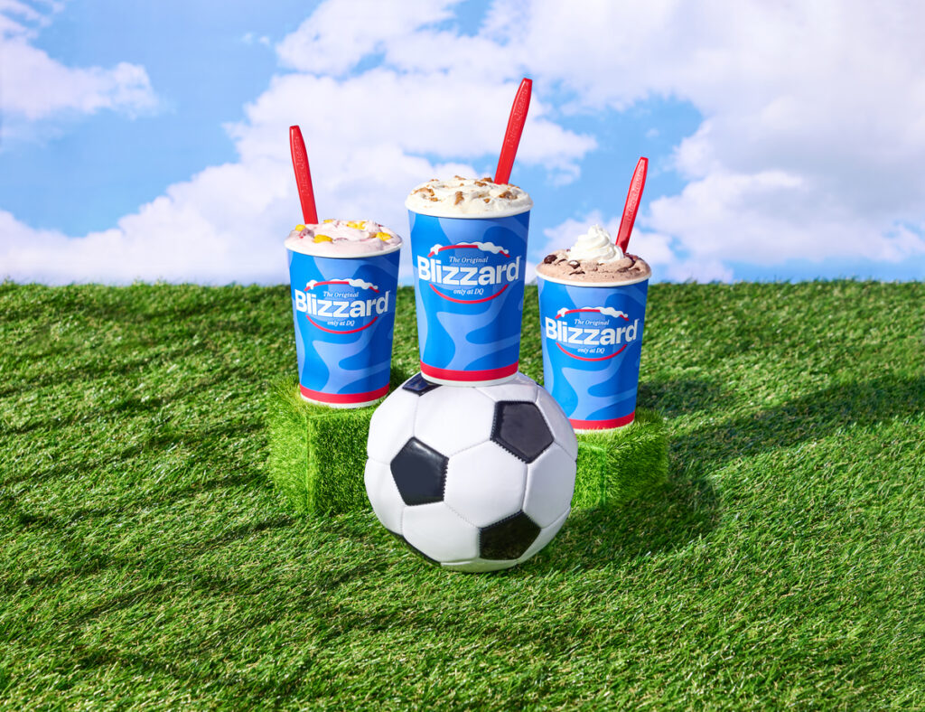 DQ Summer Treats - image of three different blizzards resting on grass and near a soccer ball