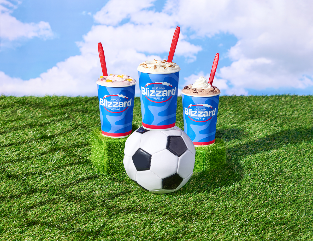 DQ Summer Treats - image of three different blizzards resting on grass and near a soccer ball