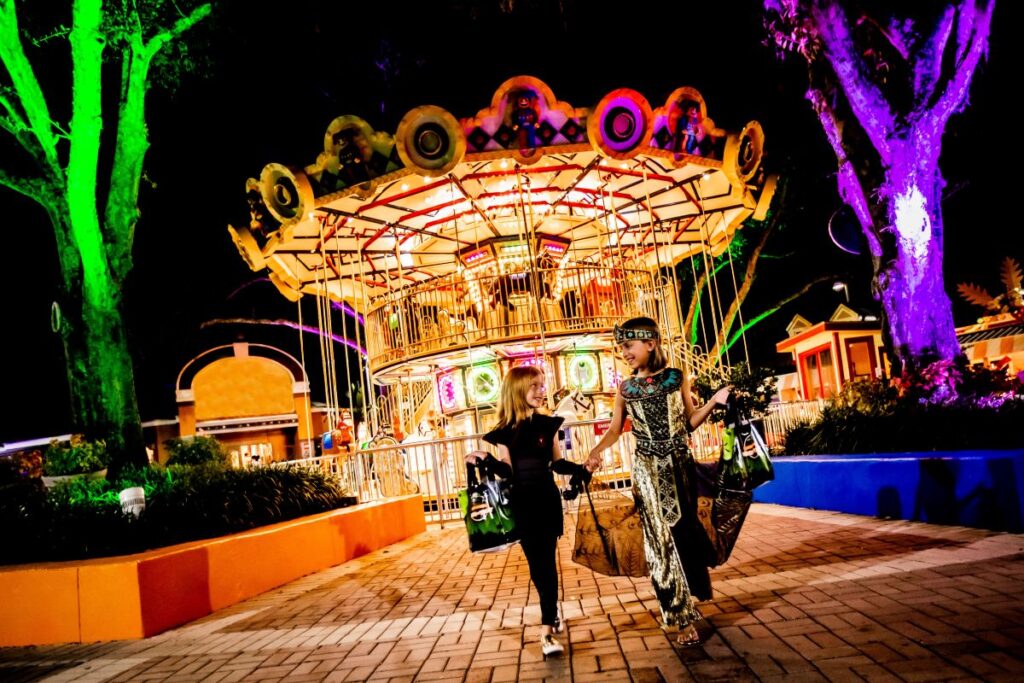 Two kids in front of the Legoland Florida carousel