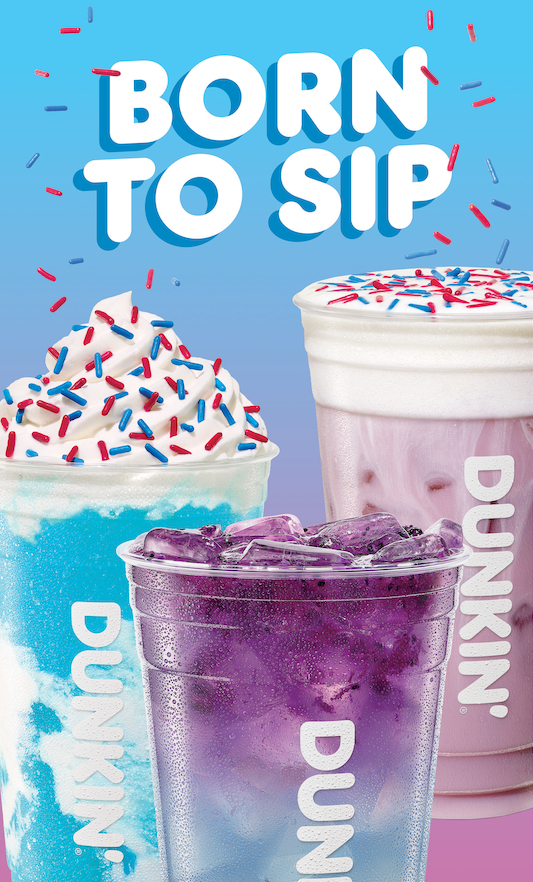 Three colorful iced drinks from the Dunkin Fourth of July menu lineup against a blue gradient background with scattered red and blue sprinkles. The bold white text at the top reads "BORN TO SIP". On the left is a vibrant blue blended drink topped with whipped cream and patriotic sprinkles. In the foreground is a dark purple iced drink filled with ice. On the right is a light pink iced drink topped with cold foam and red and blue sprinkles.