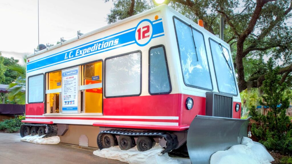The exterior of the I.C. Expeditions ice cream stand at Disney's Blizzard Beach, themed to look like a red and white snowcat vehicle.