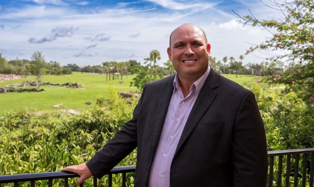 Jon Vigue, Busch Gardens president, seen with background of animal area at Busch Gardens Tampa Bay