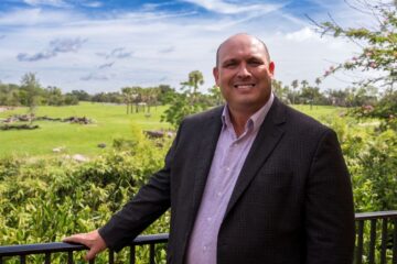 Jon Vigue, Busch Gardens president, seen with background of animal area at Busch Gardens Tampa Bay