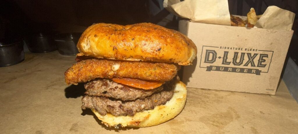 Up-close photo of Pepperoni Pizza Burger with fries on right side of it