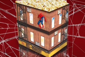 Promotional flyer for Regal displaying a highly detailed "Wall Crawler Popcorn Tin," a unique piece of Spider-Man theatre merchandise shaped like a brick New York City apartment building with a small Spider-Man figure crawling on the wall above a corner deli-grocery awning.
