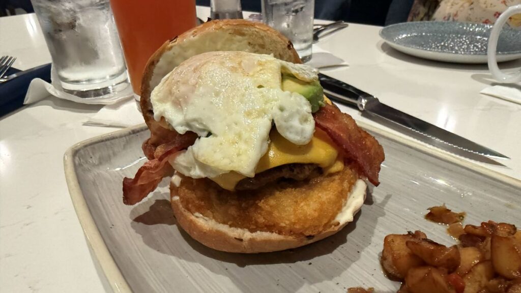 Steakhouse 71 Breakfast Burger, with bun removed, showing a fried egg on top.