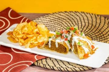 Harambe Market Menu update promotional photo showing the Tanzanian Meat Pie with chips