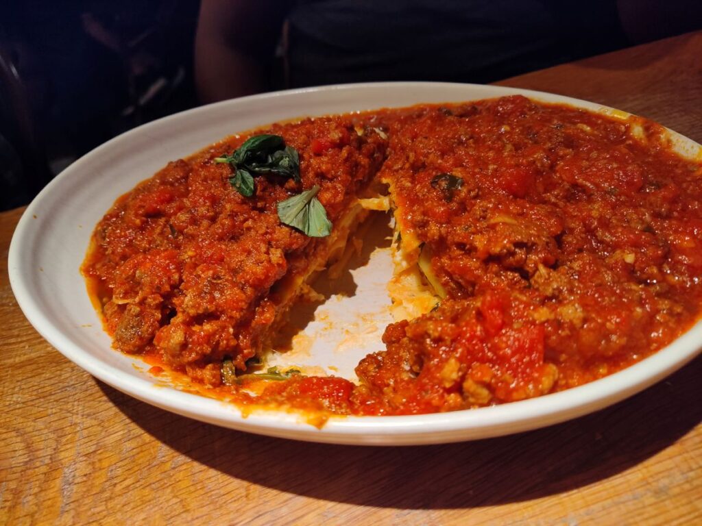 Terralina Crafted Italian House Lasagna, shown in a white bowl covered in red sauce