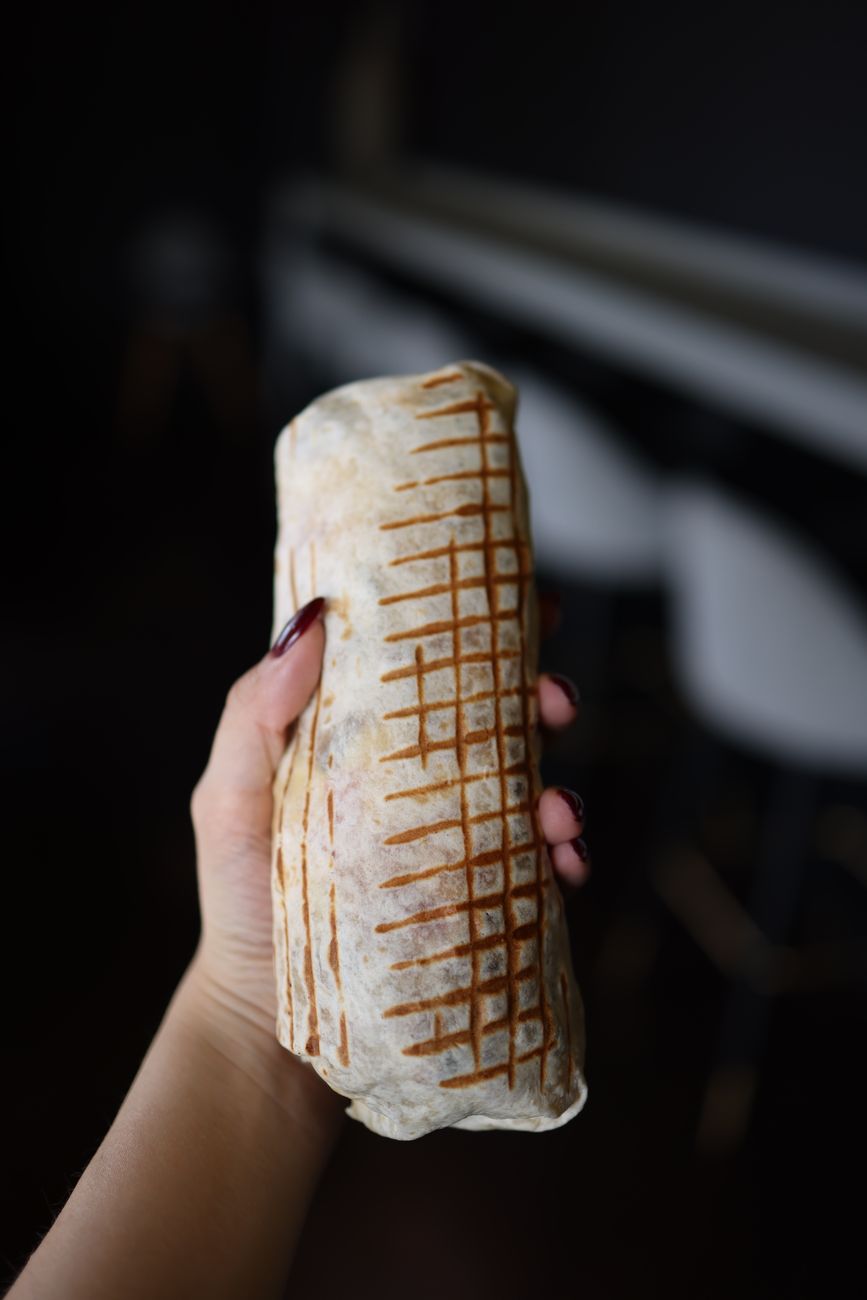 hand holding burrito for Chipotle Soccer Jersey BOGO offer