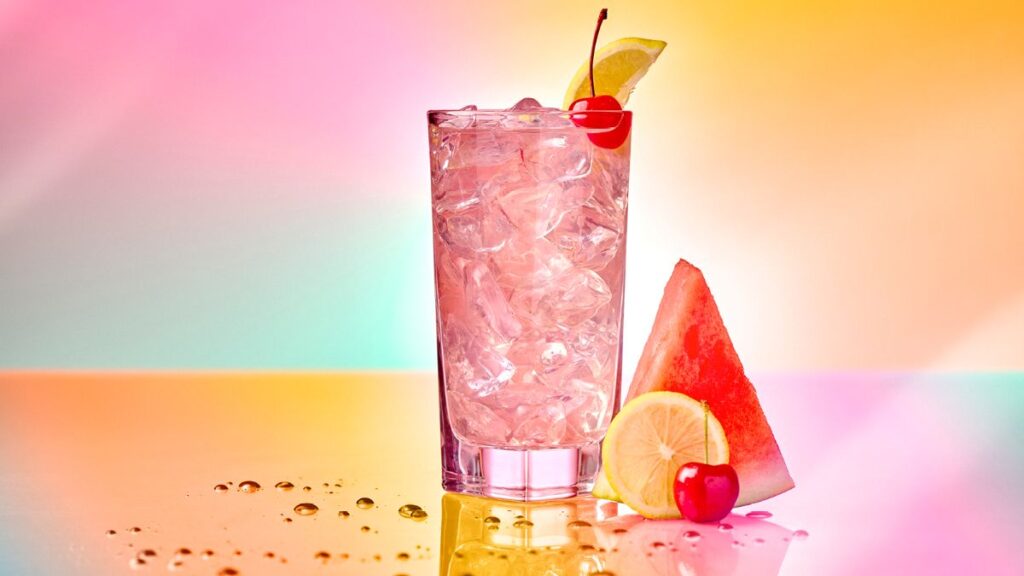 The Tipsy Watermelon cocktail with a cherry and lemon garnish served at Chez Alcatraz