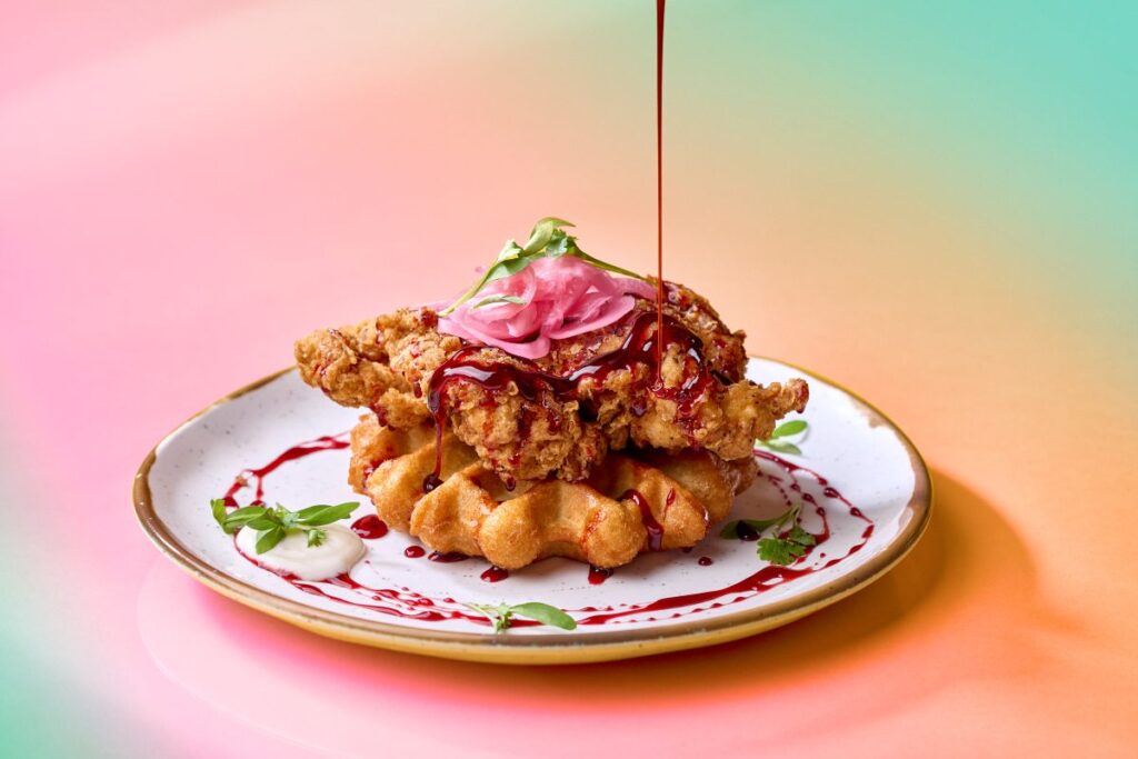 Island Fire Chicken and Waffles drizzled with sauce at Bob Marley - A Tribute to Freedom