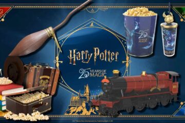 Harry Potter 25th anniversary image featuring a broom, books, popcorn, Hogwarts Express train, suitcase, popcorn buckets, and golden snitch, set against a blue magical background.
