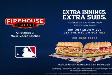 An advertisement for the MLB Firehouse Subs deal featuring two sub sandwiches on a dark blue background. The graphic promotes a "Buy one medium sub, get one free" offer using code EXTRA if any weekend MLB game goes into extra innings, redeemable Monday through Wednesday on the app or online.