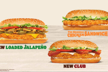 An advertisement for the new Burger King chicken sandwiches showcases three different options on long, sesame seed buns. On the left is the "New Loaded Jalapeño" sandwich, which features a crispy chicken patty topped with melted cheese, jalapeño slices, crispy fried onions, lettuce, and tomato. On the top right is "The Original Chicken Sandwich," featuring a crispy chicken patty, lettuce, and mayonnaise. On the bottom right is the "New Club" sandwich, topped with crispy chicken, bacon, cheese, tomato, and lettuce. The Burger King logo is in the bottom left corner against a light, neutral background.