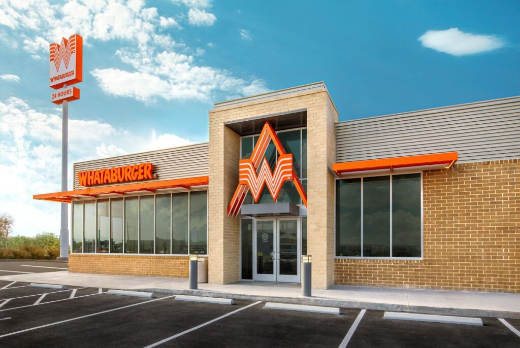 Exterior front view of a modern Whataburger restaurant with signature orange Flying W logo