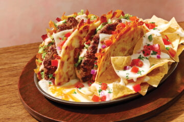 The new Applebee's O-M-Cheese-adilla Burger comes served in a sizzling skillet with melted queso, pico de gallo, and tortilla chips.