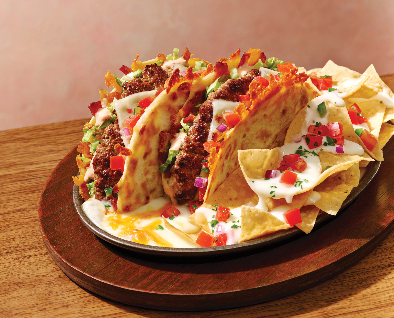 The new Applebee's O-M-Cheese-adilla Burger comes served in a sizzling skillet with melted queso, pico de gallo, and tortilla chips.