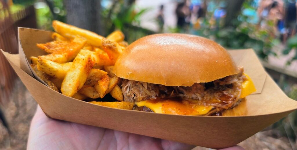 Kookaburra Kitchen BBQ burger topped with pulled pork and melted cheese served with french fries in a paper boat at Aquatica Orlando