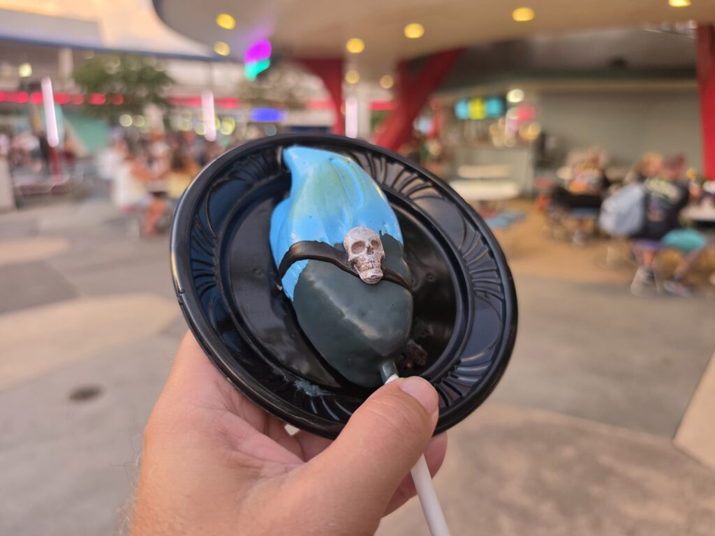 Close-up of a Hades Cake Pop treat served on a black plate at Magic Kingdom.