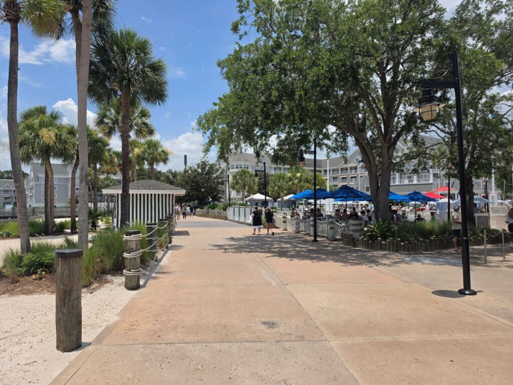 Outdoor paved walkway and seating area with blue umbrellas at Hurricane Hanna's Waterside Bar & Grill