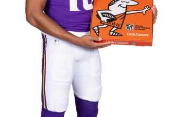 Justin Jefferson holding a Little Caesars pizza box as part of the Little Caesars NFL partnership