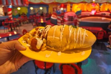 Side angle of Morris's Mac-nificent Mac & Cheese Cone stuffed with macaroni, cheese, and buffalo chicken drizzled with sauce.