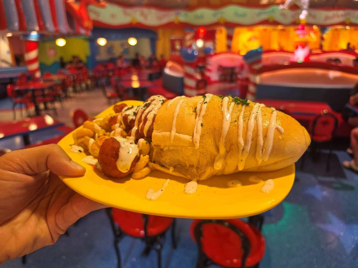 Side angle of Morris's Mac-nificent Mac & Cheese Cone stuffed with macaroni, cheese, and buffalo chicken drizzled with sauce.