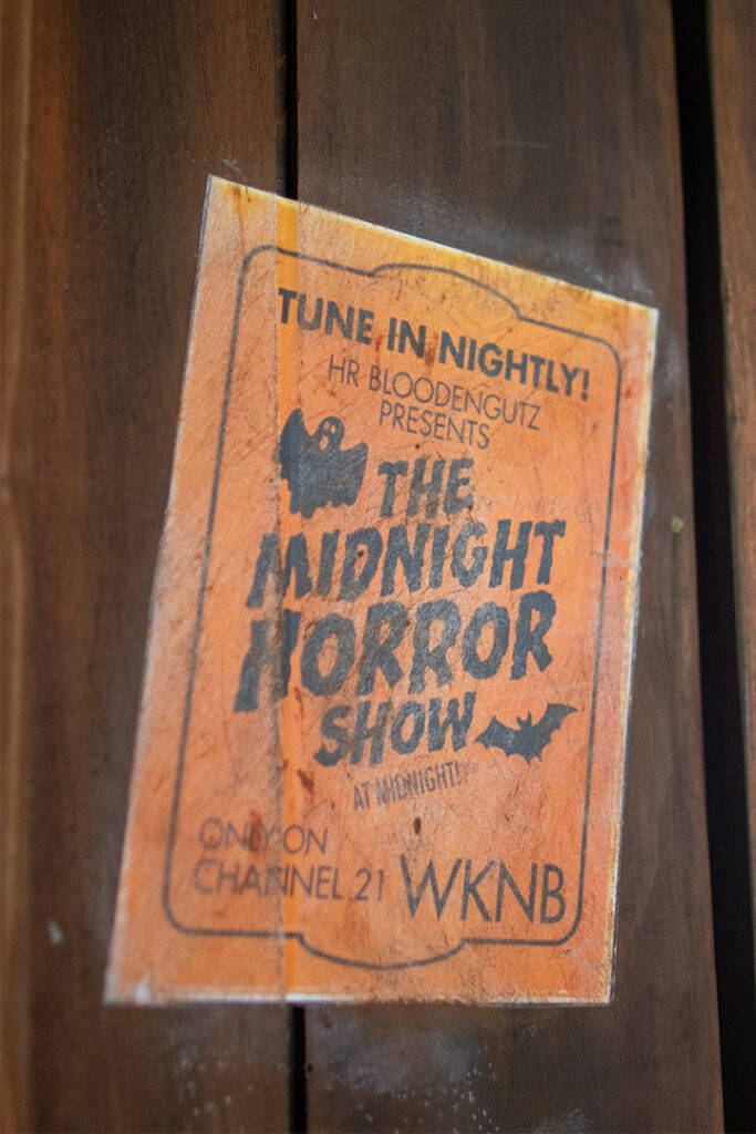 Vintage flyer taped to wood for HR Bloodengutz Presents The Midnight Horror Show on Channel 21 WKNB