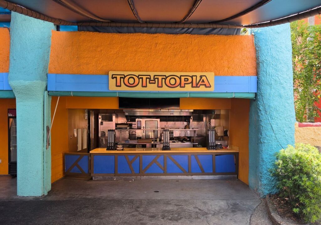 Front exterior view of the Tot-Topia quick-service food counter featuring blue and orange architecture.