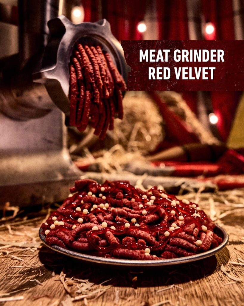 Meat Grinder Red Velvet dessert styled to look like ground meat coming out of a meat grinder on a tray for Halloween Horror Nights 35.