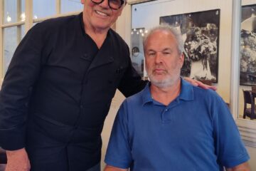 Wolfgang Puck and Jon Self taking a photo together inside the restaurant